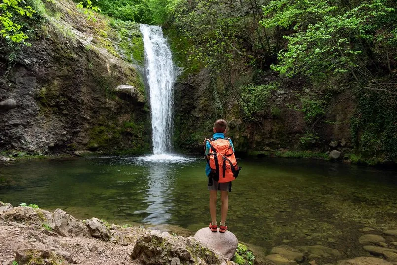 Beste reistijd Bulgarije - reiziger bij een waterval in de Rhodope bergen.