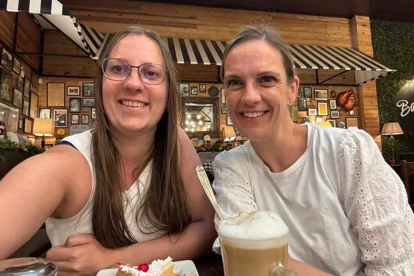 Productmanager Elise en Reisexpert Petra in een cafe.