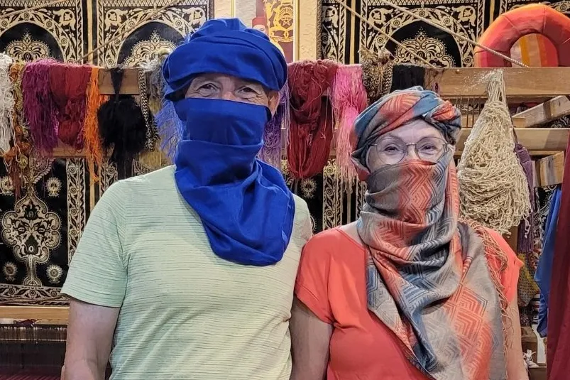 Een man en een vrouw die sjalen dragen als woestijnkleding gewikkeld om hun hoofd. 