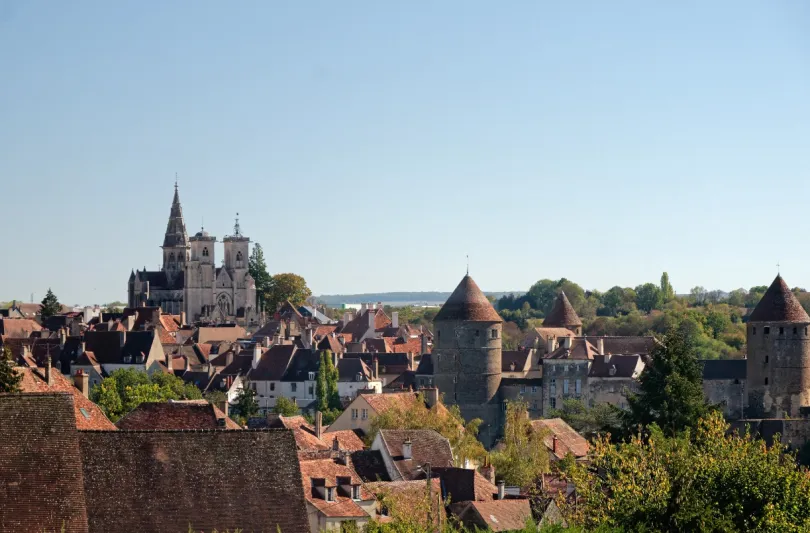 Uitizicht op de daken van het dorpje Semur-en-Auxois in Bourgogne waarbij de kathedraal uitsteekt boven de dagen. 