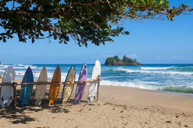 Surfboards staan tegen een hek op het strand Playa Cocles in Costa Rica.