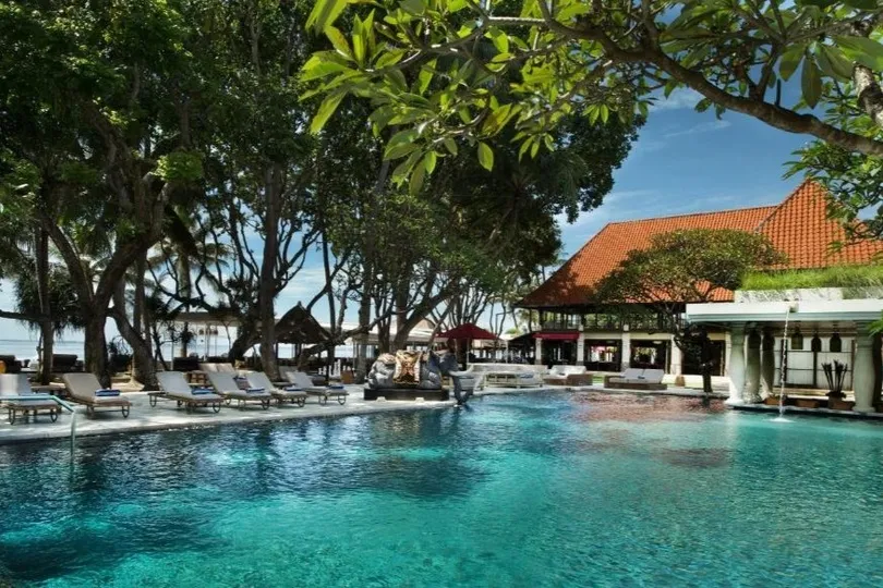 Resort met zwembad en ligbedden.