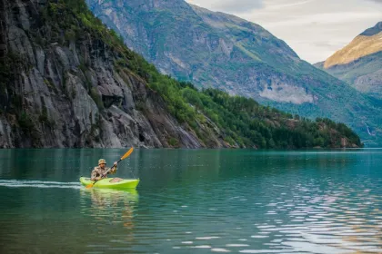 Man aan het kajakken tussen de fjorden.
